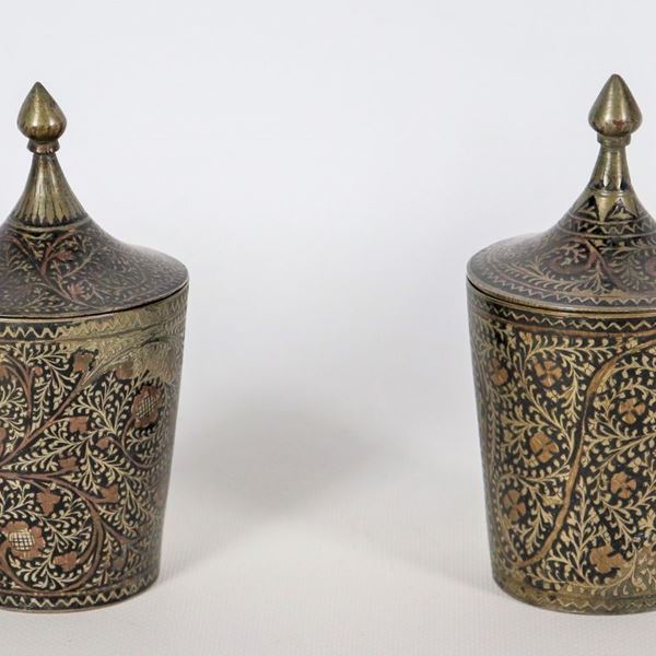 Coppia di piccoli vasi orientali in metallo bronzato, interamente decorati a rilievo a volute floreali