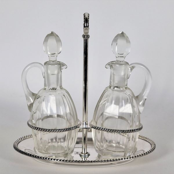 Silver-plated metal cruet with chiseled and embossed edges, two crystal ampoules
