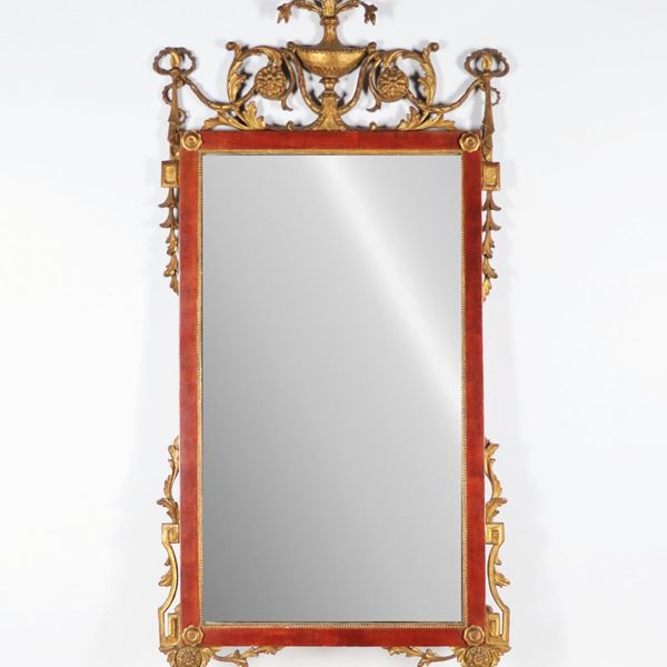 Ancient mirror in lacquered wood, with gilded and carved friezes with Louis XVI motifs of volutes, calatines of flowers and rosettes, amphora with bunch of flowers on the cornice