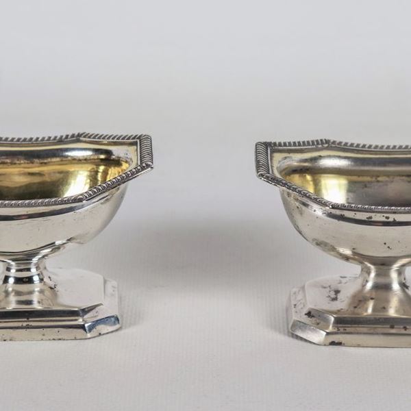 Pair of George III period silver salt cellars with chiseled and embossed edges, gr. 160