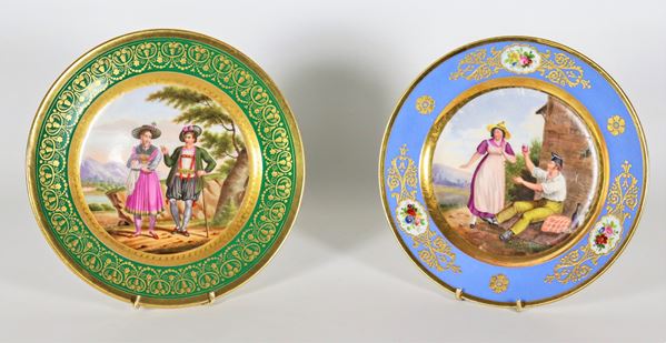 Lot of two plates in French porcelain in various polychromes, with painted medallions and pure gold highlights, "Habitans de la vallée de Zitter Tyrol" marked Baruch Weil 16 Rue Bondy in Paris and "Canton de Vaud" marked DARTE Palais Royal n. 21