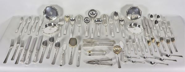 Important silver cutlery set with four coasters, chiseled and embossed with neoclassical motifs with engraved monogram. Branded A. Foschiatti-Trieste (215 pcs), gr. 10390