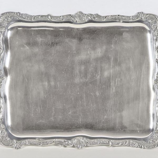 Rectangular tray in silver-plated metal, with handles and edges chiseled and embossed with motifs of scrolls and curls