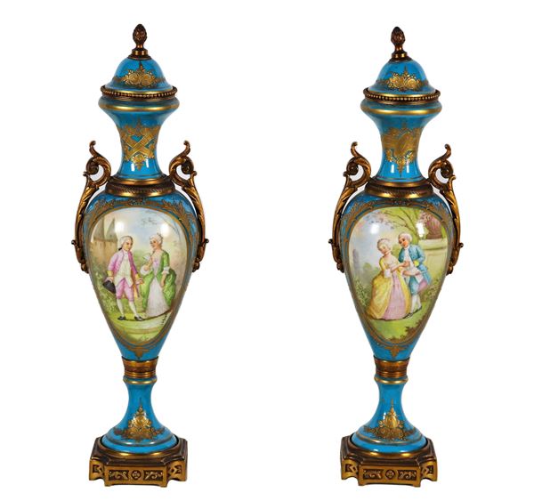 Pair of ancient Sèvres turquoise porcelain potiches, with medallions painted with gallant scenes and landscapes, handles, bases and seals in gilded and chiselled bronze