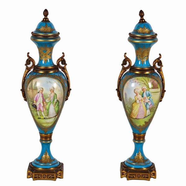 Coppia di antiche potiches in porcellana turchese di Sèvres, con medaglioni dipinti a scene galanti e paesaggi, manici, basi e guarnizioni in bronzo dorato e cesellato