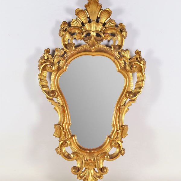 Ancient small mirror of the Louis XV line, in gilded wood and carved with scrolls of acanthus leaves and shell on the cymatium, mercury mirror