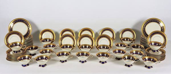 Service of 24 tea cups with saucers and 26 dessert plates in German porcelain, with pure gold edges and cobalt blue band with floral interlacing (50 pcs)