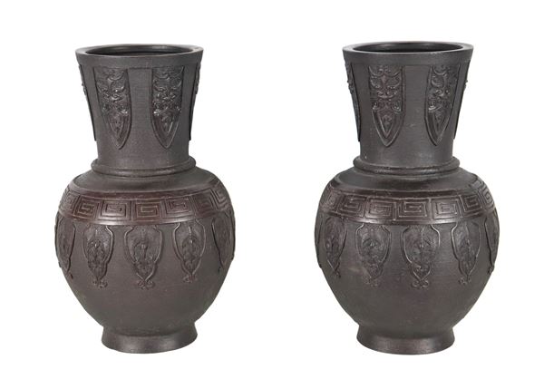 Pair of Chinese vases in black patinated terracotta, with relief decorations with oriental motifs