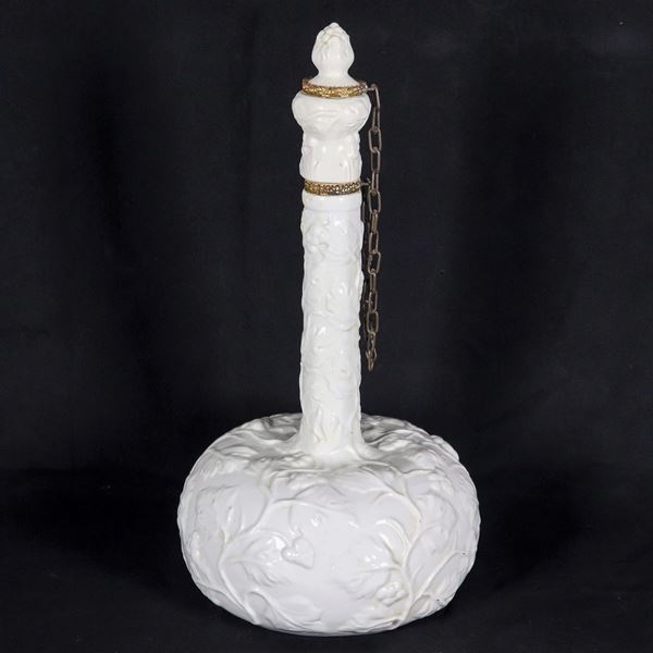 Wine flask in white French porcelain, with relief decorations with motifs of branches and bunches of grapes, gilded metal trimmings