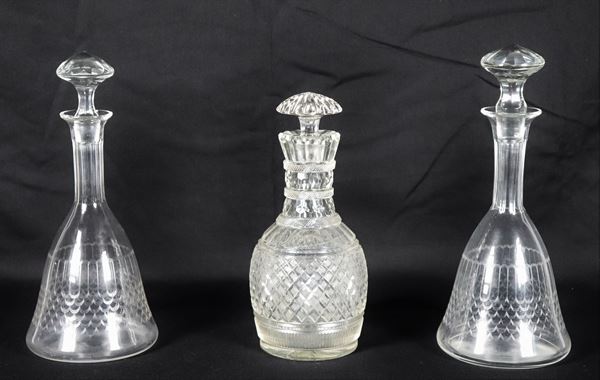 Lot of three Art Nouveau wine bottles in worked crystal, two forming a pair, slight flaw at the base of one bottle