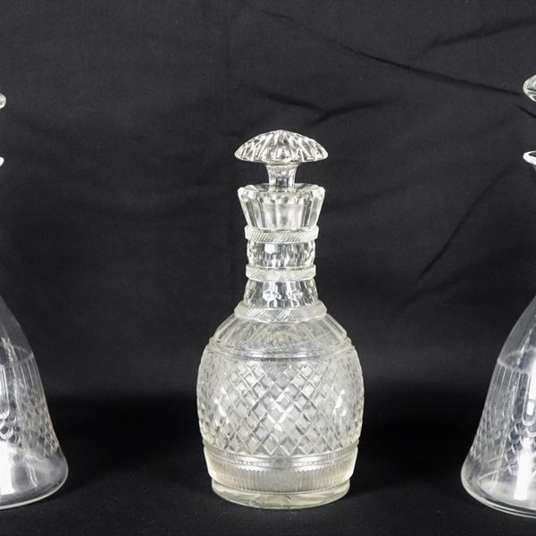 Lot of three Art Nouveau wine bottles in worked crystal, two forming a pair, slight flaw at the base of one bottle