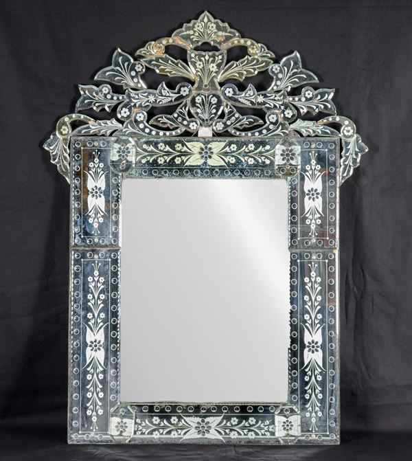 Murano glass mirror with floral motif engravings and perforated cymatium