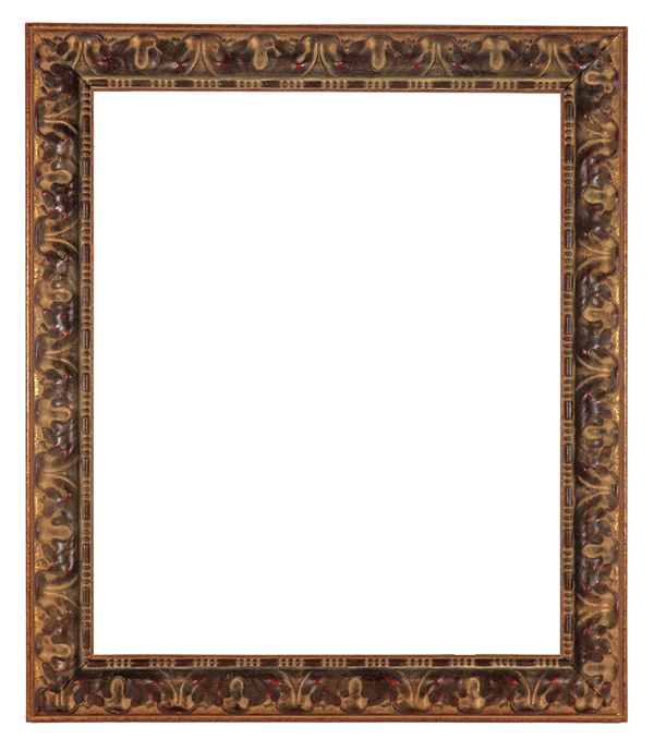 Ancient patinated wooden frame, gilded and carved with plant motifs