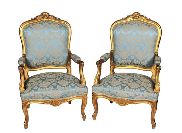 Pair of Roman armchairs from the Louis XV line, in gilded wood and carved with acanthus leaf and shell motifs, armrests and curved legs. Damask fabric cover