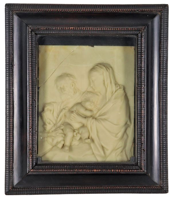 "Holy Family", small plaque in alabaster marble in an ebonized wooden noticeboard frame. Some breakages