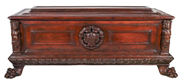 Ancient Umbrian chest in walnut, with carved noble coat of arms in the center and uprights with sculptures of caryatids, legs with lion's paws