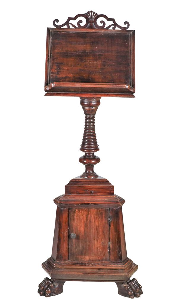 Antique large walnut floor lectern supported by a turned column, triangular base with door and three lion's paw legs