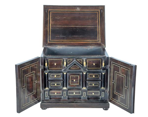 Ancient small walnut coin chest with geometric inlays, series of drawers and columns inside, opening top and two doors underneath, some lacks