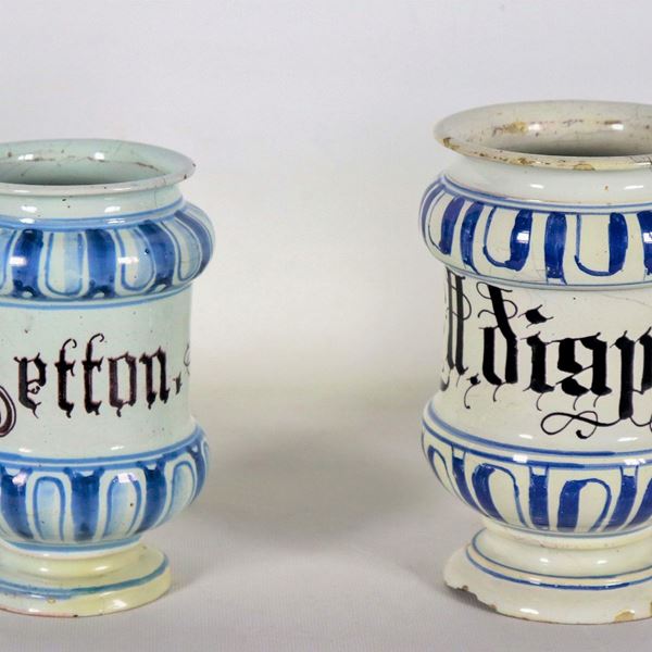 Lotto di due albarelli da farmacia in maiolica veneta, con decorazioni in blu e nero. Difetti alle basi e al bordo di un collo 
