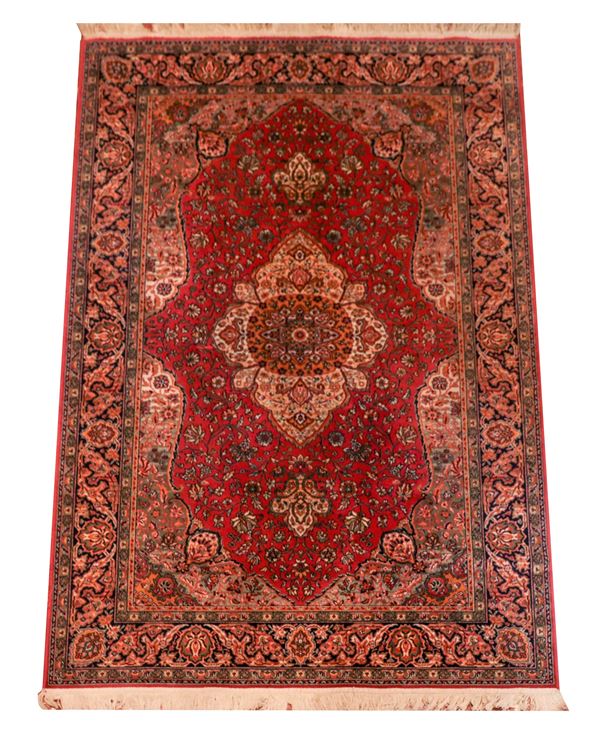 Persian carpet with floral and geometric design on a red and havana background, M 2.36 X 1.47