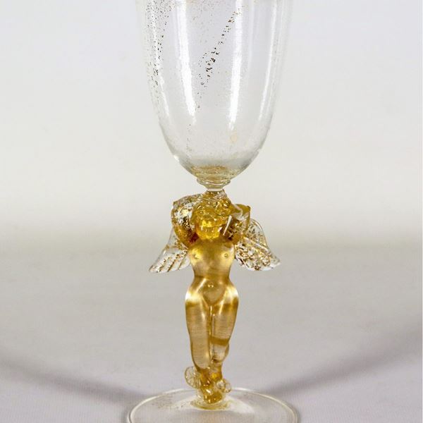 Murano blown glass glass with golden flakes, the stem with "Winged Putto" figurine. One wing is glued