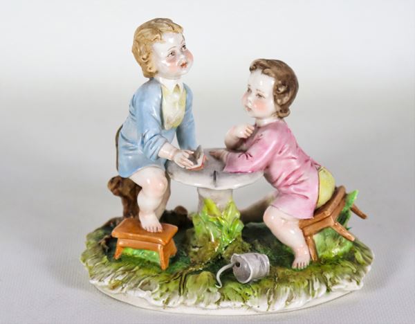 Small group "Children playing" in Capodimonte polychrome porcelain, slight defects