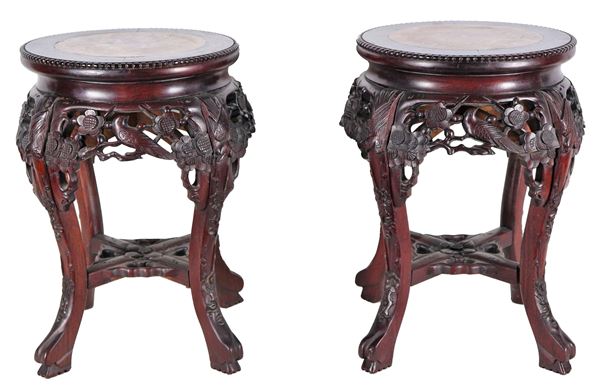 Pair of Chinese stools in teak wood, with carvings of exotic flower and bird motifs, four curved legs and marble tops