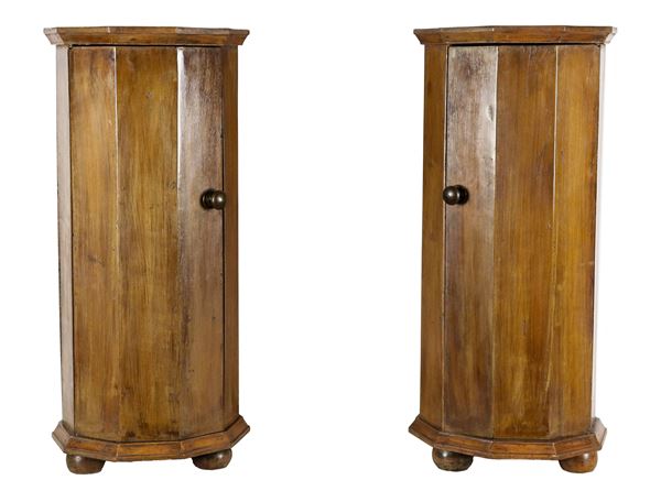 Pair of antique walnut bedside tables in the shape of faceted columns, one central drawer each