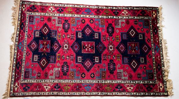 Persian carpet with a red background