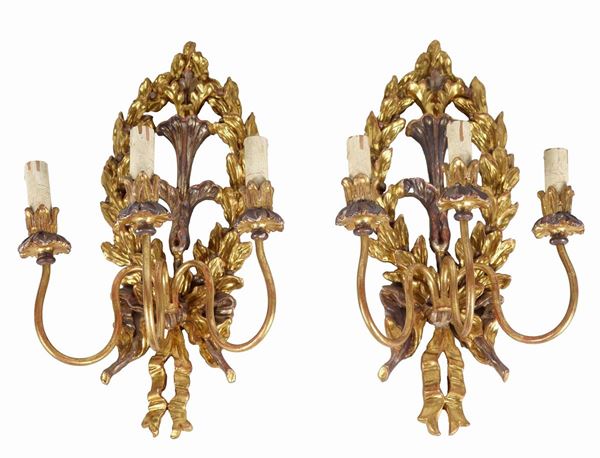 Pair of Louis XVI wall sconces in gilded, silvered and carved wood, three lights each