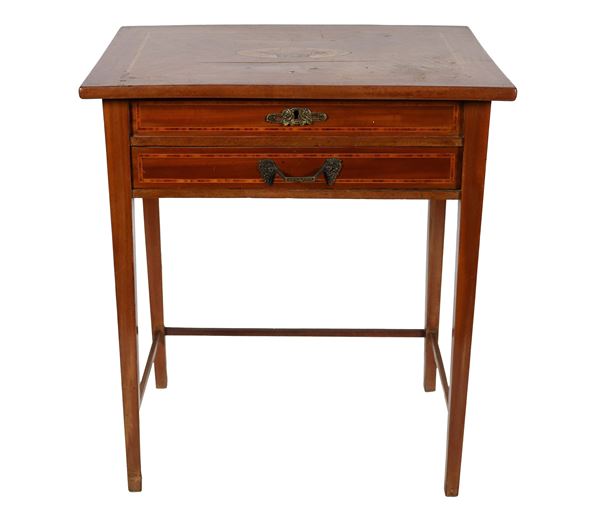 Work table in mahogany and bois de rose, with geometric thread inlays and medallion on the top with basket of flowers inside. Folding top with mirror and compartments inside, a drawer underneath and four legs in the shape of an inverted pyramid joined together by a small cross