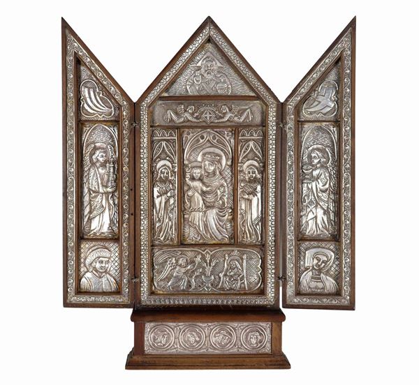 Religious triptych in wood and silvered metal, embossed and chiselled, with "Madonna with Child and Saints" in the center