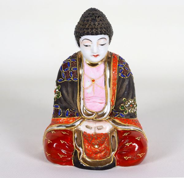 Small oriental sculpture "Buddha" in porcelain, with relief enamel decorations with floral motifs