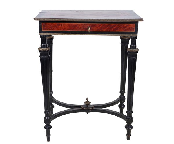 Antique French center table with a rectangular shape, in ebonized wood and thuja briar with geometric pattern inlays, folding top with compartments and mirror inside, four fluted cone legs joined by a shaped cross