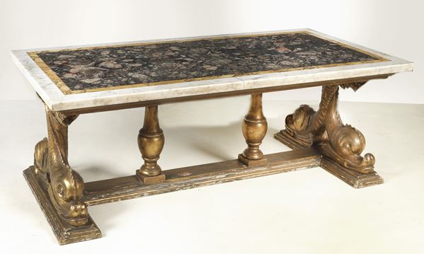 Living room table in gilded wood, base with sculptures of crossed dolphins and top in various precious marbles