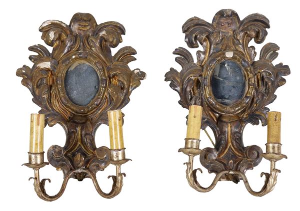 Pair of small antique gilded and silvered Mecca sconces in wood with acanthus leaf carvings, oval mercury mirrors in the centre, 2 lights each