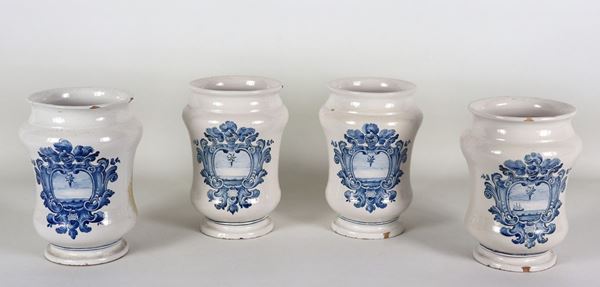 Lot of four Italian majolica albarelli with blue decorations of noble coats of arms, various defects and slight lacks