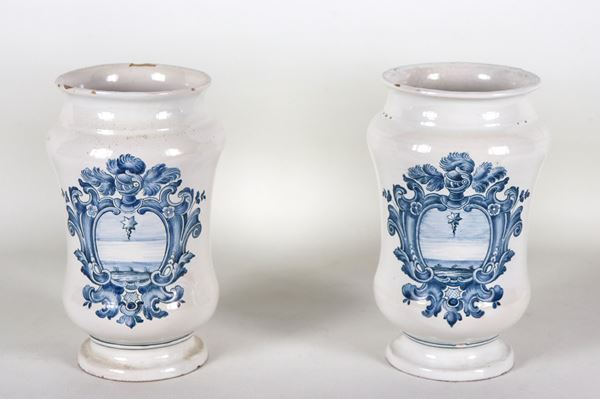 Pair of Italian majolica albarelli with blue decorations of noble coats of arms, slight defects