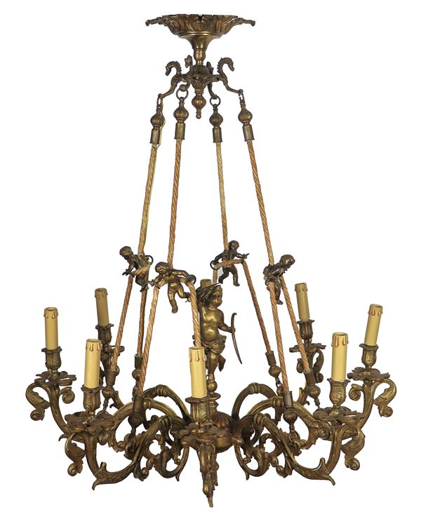 Gilded bronze chandelier with sculptures of putti and volutes, 8 lights