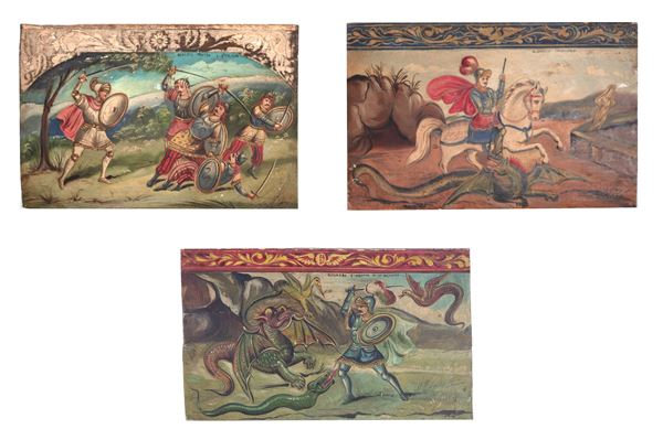 Lotto di tre pannelli in legno di carretto siciliano, decorati e dipinti con scene dell'Orlando Furioso