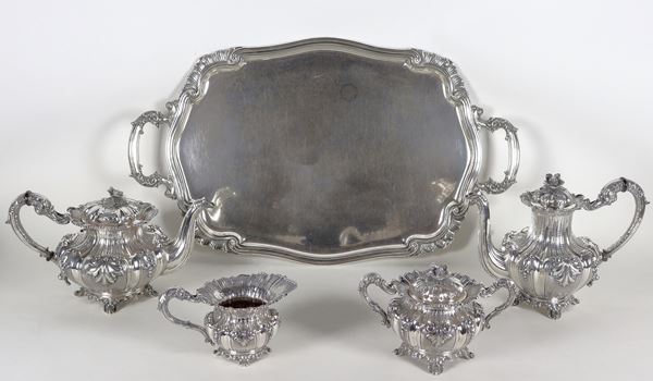 Silver tea and coffee service with curved tray, entirely chiseled and embossed with Louis XV motifs. Fascio Period Stamp. The service is marked Buzzetti (5 pieces), gr. 6140
