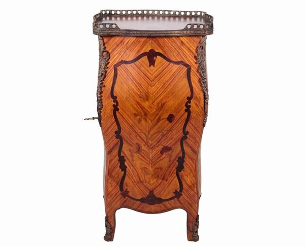 French coin cabinet in bois de rose and purple ebony, with a curved and rounded rectangular shape, entirely inlaid with scrolls and flowers. Top with perforated railing and a door with six small pulls inside, gilded and chiseled bronze seals