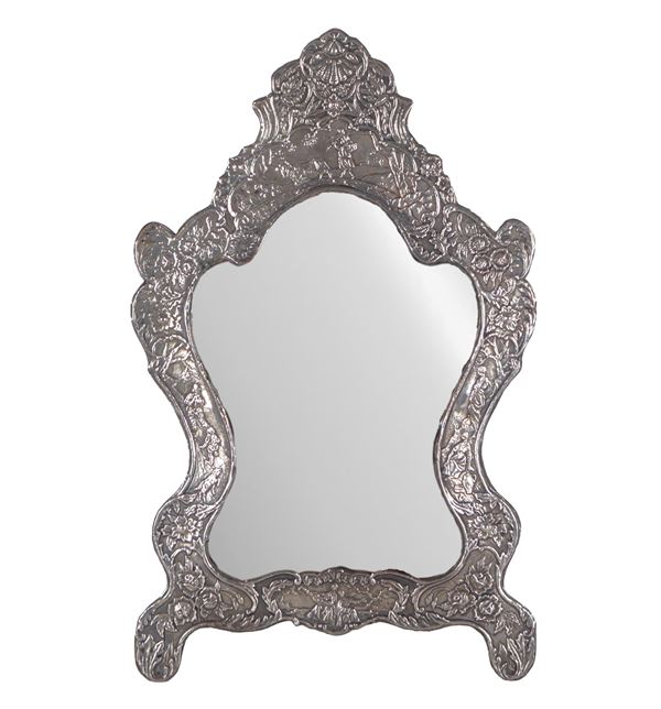 Ancient small mirror in silvered copper, embossed and chiseled with motifs of scrolls, floral garlands and peasant scenes