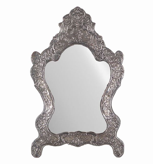 Ancient small mirror in silvered copper, embossed and chiseled with motifs of scrolls, floral garlands and peasant scenes