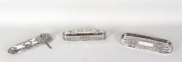Lot in chiselled and embossed silver of a small oval box, a glasses holder and an oval tray, gr. 300
