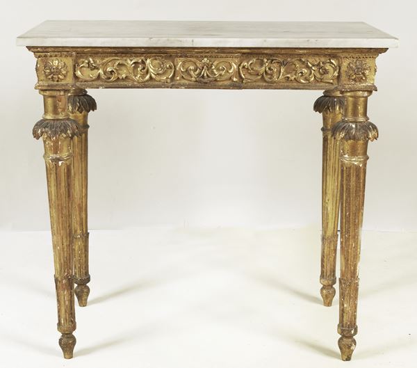 Ancient Roman Louis XVI console, in gilded wood carved with floral scrolls, acanthus leaves and rosettes, four fluted cone legs and gray marble top from a later period