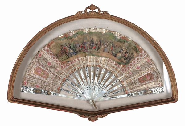 Antique mother-of-pearl fan with printed and colored party scene between nobles, gilded wood noticeboard frame