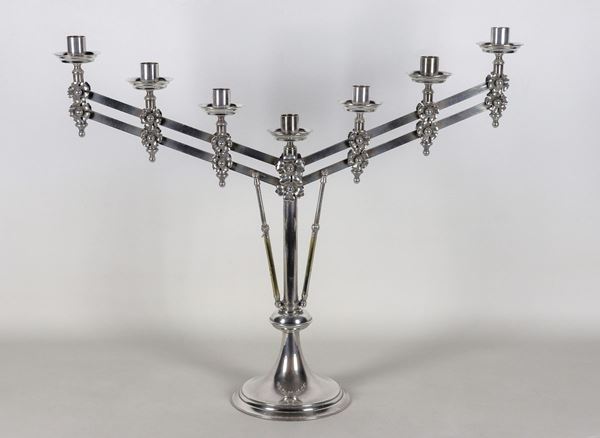Menorah candelabra in silvered metal, embossed and chiselled with seven flames