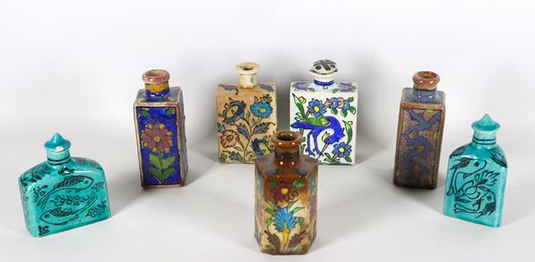 Lot of seven oriental majolica bottles, with colorful decorations with various motifs, different shapes and sizes