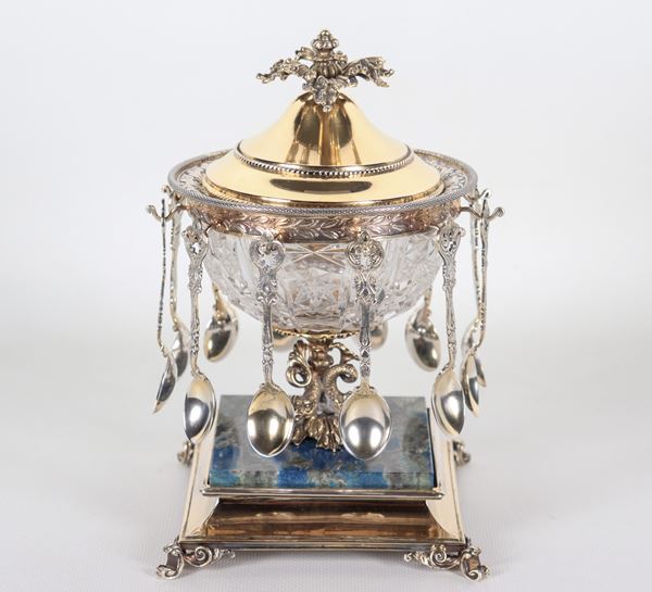 Sugar bowl with twelve cup-shaped teaspoons, in silver vermeil, crystal and veined blue marble, chiseled and embossed with Empire motifs, supported by small sculptures of dolphins, resting on a square base with four curved feet